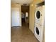 Hallway featuring a laundry area with stacked washer and dryer, plus stairs at 1270 Westside Dr, Winter Garden, FL 34787