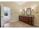 Bathroom boasting double vanity, dark wood cabinets, and views to the outdoor pool at 1601 Carillon Park Dr, Oviedo, FL 32765