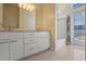 Bathroom featuring a large mirror, white vanity, and a tub with shower at 1601 Carillon Park Dr, Oviedo, FL 32765