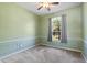 Cozy bedroom with a large window and decorative trim on the lower walls at 1601 Carillon Park Dr, Oviedo, FL 32765