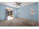 Light-filled bedroom featuring a ceiling fan and sliding glass doors to the outdoor patio at 1601 Carillon Park Dr, Oviedo, FL 32765