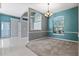 Elegant dining room with chandelier lighting, carpet, and a large window for natural light at 1601 Carillon Park Dr, Oviedo, FL 32765