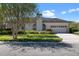 Well-maintained single-story home with a manicured lawn, a two-car garage, and a tile roof at 1601 Carillon Park Dr, Oviedo, FL 32765