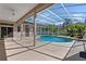 Inviting screened pool area featuring a covered patio with ceiling fan, blending indoor and outdoor living at 1601 Carillon Park Dr, Oviedo, FL 32765