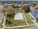 Community sand volleyball court with manicured lawn, walking path and decorative neighborhood sign at 1601 Carillon Park Dr, Oviedo, FL 32765