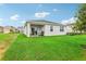 Green backyard with a covered patio perfect for outdoor relaxation at 1718 Blue Lagoon Cir, Mascotte, FL 34753