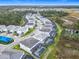 An aerial view shows new construction homes with pools and nearby wetlands at 1739 Oak Blossom Dr, Davenport, FL 33837