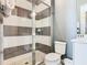 Modern bathroom featuring a glass-enclosed shower with gray and white striped tiles at 1739 Oak Blossom Dr, Davenport, FL 33837