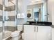 Well-lit bathroom with glass-enclosed shower, modern vanity, and neutral gray walls at 1739 Oak Blossom Dr, Davenport, FL 33837