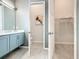 Bathroom featuring a dual sink vanity with modern fixtures and neutral colored cabinets at 1739 Oak Blossom Dr, Davenport, FL 33837