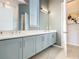 Bathroom featuring a dual sink vanity with modern fixtures and neutral colored cabinets at 1739 Oak Blossom Dr, Davenport, FL 33837