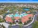 Aerial view of community pool with beach entry, splash pad, and shaded lounging at 1739 Oak Blossom Dr, Davenport, FL 33837