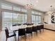 Bright dining room with large windows overlooking the pool area, modern lighting, and sleek decor at 1739 Oak Blossom Dr, Davenport, FL 33837