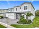 Beautifully landscaped home featuring a two-car garage and a combination of stone and stucco finishes at 1739 Oak Blossom Dr, Davenport, FL 33837