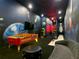 Spacious game room with Pac-Personal air hockey table, bowling lane, and galaxy-themed mural at 1739 Oak Blossom Dr, Davenport, FL 33837