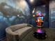 This game room offers lounge seating, space-themed decor, and an arcade game at 1739 Oak Blossom Dr, Davenport, FL 33837