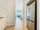 Open view of a stainless steel refrigerator with the kitchen and dining area visible in the background at 1739 Oak Blossom Dr, Davenport, FL 33837