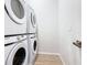 Well-lit laundry room featuring stacked Samsung washer and dryer units at 1739 Oak Blossom Dr, Davenport, FL 33837