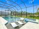 Relaxing pool area featuring sun loungers, a spa, and serene views at 1739 Oak Blossom Dr, Davenport, FL 33837