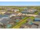 Expansive aerial view of a neighborhood with pools, solar panels, and a scenic lake in the background at 1832 Sandy Park Trl, Kissimmee, FL 34747