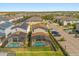 Aerial view of homes with screened-in pools and solar panels in a well-maintained neighborhood at 1832 Sandy Park Trl, Kissimmee, FL 34747