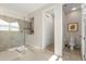 Modern bathroom featuring glass shower, neutral tile, and a separate toilet area at 1832 Sandy Park Trl, Kissimmee, FL 34747