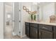 Elegant bathroom featuring a modern vanity, framed art, and an open doorway to an adjoining bedroom at 1832 Sandy Park Trl, Kissimmee, FL 34747