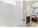 Cozy bathroom featuring a shower-tub combo, modern fixtures, and a view into an adjacent, themed bedroom at 1832 Sandy Park Trl, Kissimmee, FL 34747