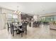 Open-concept dining area showcasing a modern chandelier and easy access to the kitchen and outdoor spaces at 1832 Sandy Park Trl, Kissimmee, FL 34747