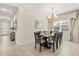 Elegant dining area featuring a stylish chandelier and a bright window that floods the space with natural light at 1832 Sandy Park Trl, Kissimmee, FL 34747