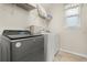 Well-lit laundry room with modern Whirlpool washer and dryer, shelving, and tiled floors for easy maintenance at 1832 Sandy Park Trl, Kissimmee, FL 34747