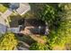 Overhead view of home with a long driveway, mature trees, and dark shingles on the roof in a suburban setting at 1899 Valley Wood Way, Lake Mary, FL 32746