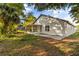 View of the back of the home from the yard with a screened in patio at 1899 Valley Wood Way, Lake Mary, FL 32746