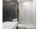 Modern bathroom with black hexagon tile wall and glass shower at 1899 Valley Wood Way, Lake Mary, FL 32746