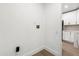 Interior view of a hallway next to the kitchen, featuring white walls and light-colored wood flooring at 1899 Valley Wood Way, Lake Mary, FL 32746