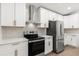 Modern kitchen featuring stainless steel appliances, white cabinetry, and stylish backsplash at 1899 Valley Wood Way, Lake Mary, FL 32746