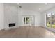 Bright living room with fireplace and a large window overlooking a manicured backyard at 1899 Valley Wood Way, Lake Mary, FL 32746