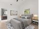 A staged main bedroom with an en suite bath, carpet, furniture, decor, and a ceiling fan at 1899 Valley Wood Way, Lake Mary, FL 32746