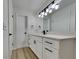 Bright bathroom featuring a white vanity, modern fixtures, and a tiled shower with natural light at 202 Ramsbury Ct, Longwood, FL 32779