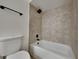 Bathroom featuring tub with tile surround and modern black fixtures at 202 Ramsbury Ct, Longwood, FL 32779