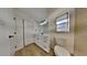 Bright bathroom featuring a white vanity, modern fixtures, and a tiled shower with natural light at 202 Ramsbury Ct, Longwood, FL 32779