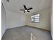 Carpeted bedroom featuring fan, closet, and natural light at 202 Ramsbury Ct, Longwood, FL 32779