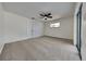 Bright bedroom with a ceiling fan, neutral carpet, and a sliding glass door at 202 Ramsbury Ct, Longwood, FL 32779