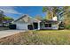 Charming single-Gathering home featuring stone accents, a two-car garage, and a well-maintained lawn at 202 Ramsbury Ct, Longwood, FL 32779