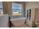 Bright bathroom features a modern soaking tub, and large window for natural light at 2055 Quiet Cv, Sanford, FL 32771