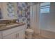 Bathroom with custom blue wallpaper and shower-tub combo at 2055 Quiet Cv, Sanford, FL 32771