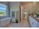 Bathroom with soaker tub, wood look tile and an open design at 2055 Quiet Cv, Sanford, FL 32771