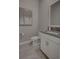 Modern powder room featuring sleek vanity with light gray countertop, tile flooring and modern fixtures at 2055 Quiet Cv, Sanford, FL 32771