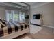 Bright bedroom featuring a four-poster bed, TV, and light wood floors at 2055 Quiet Cv, Sanford, FL 32771