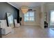 Bright dining room featuring a stylish chandelier, modern tile flooring, and black accent wall at 2055 Quiet Cv, Sanford, FL 32771